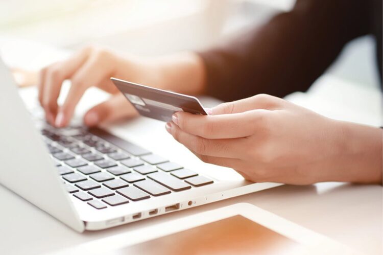 Person using keyboard with credit card